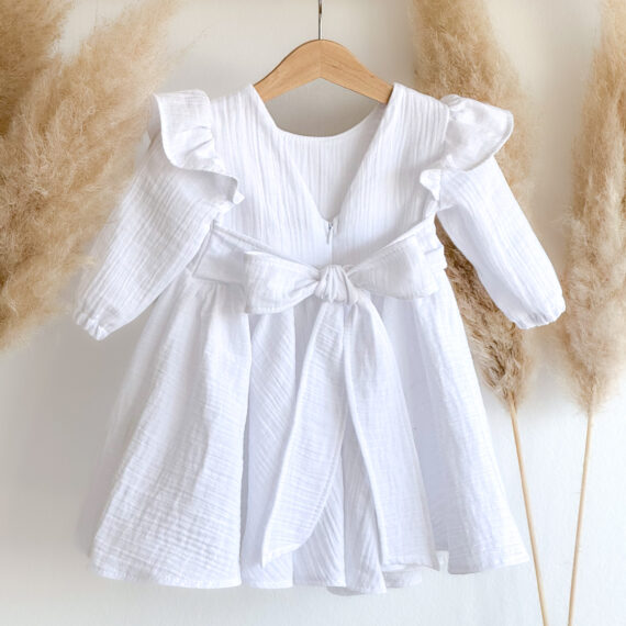 Bijela krsna haljina Bianca izrađena od muslin materijala s mašnom na leđima i volančićima na ramenima.
