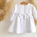 Haljina za krštenje od muslina, u bijeloj boji, visi na vješalici.