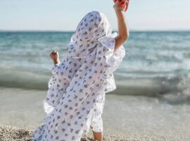 Dijete u dječjem ponču na pješčanoj plaži.
